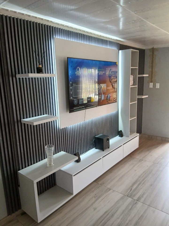 Custom entertainment wall with fluted panels, shelving and TV unit