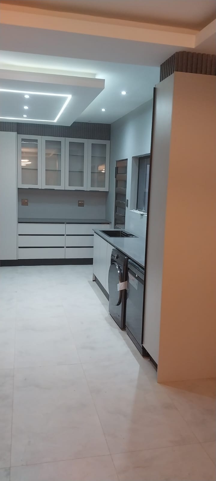 Custom glass-fronted cabinetry and storage